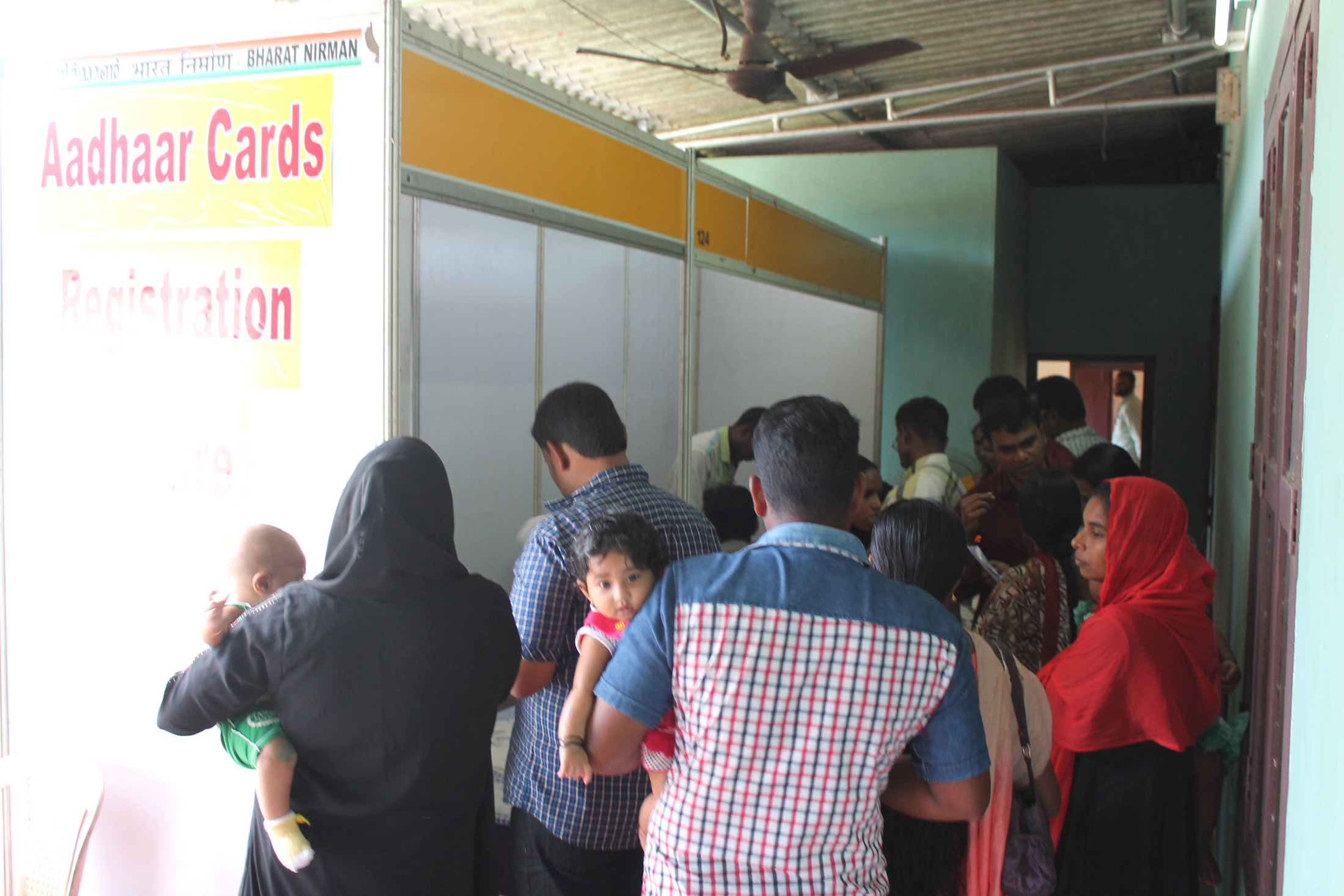 Indian worker completing biometric and Aadhaar verification at registration desk